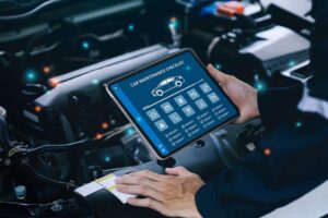 car service and checking concept. Hand of a mechanic holding the tablet for maintenance checklist vehicle, Software for manager check to repair, technology checkup automotive. Customer service concept