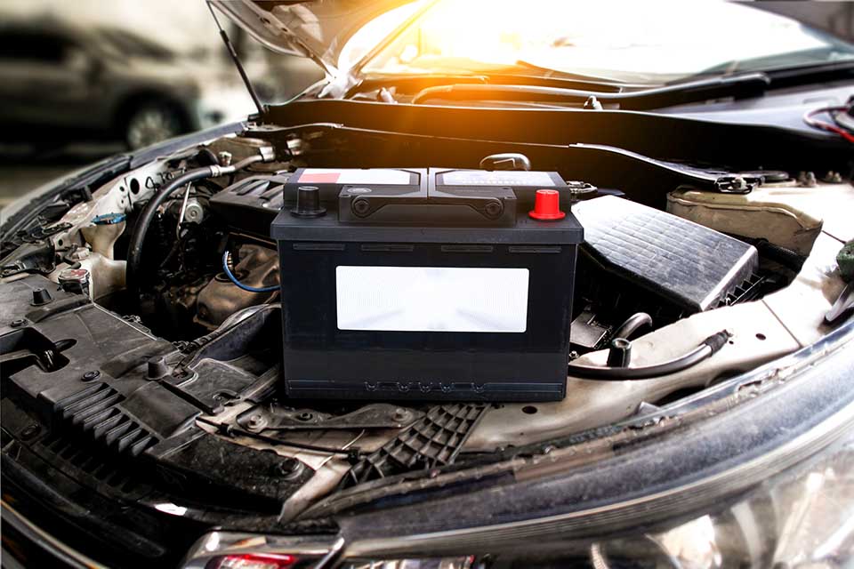 Car battery with blank white sign , battery placed on engine compartment for car electronic system , Car maintenance concept